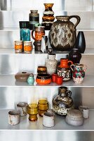 Collection of old seventies vases on metal shelves