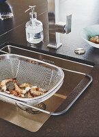 A sink with a stainless steel sink sieve