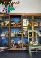Collection of old crockery in glass-fronted cabinet