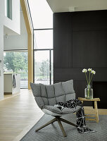 Upholstered designer armchair in modern architect-designed house