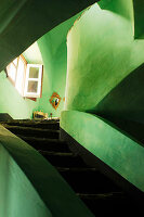 Rustic stairwell with green limewashed walls
