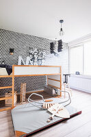 Child's bedroom in black, white and grey with graphic wallpaper pattern