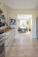 Open doorway leading from kitchen into sunny dining room