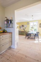 Open doorway leading from kitchen into sunny dining room