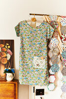 Floral summer dress on coat hanger and fabric swatches