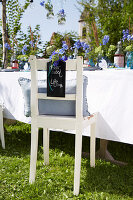 Rustic garden chair with place card for summer party