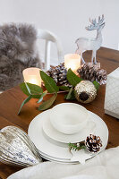 White crockery and Christmas decorations on wooden table