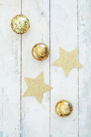 Stars and gold balls on festive surfacee