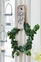 DIY wreath from eucalyptus branches with hanger from linen fabric