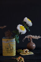 White chrysanthemums (Chrysanthemum) in a vintage tin