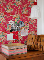 Box covered with washi tape in front of red Asian wallpaper