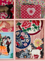Typecase lined with patterned paper and kitschy decoration