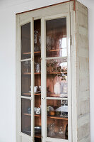 Shabby display cabinet with dishes