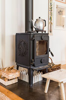 Cast iron wood-burning stove with squirrel motif and rustic accessories