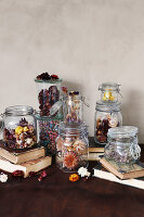 Dried flowers in preserving jars on old books