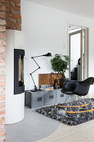 Rocking chair in front of Industrial-style, low sideboard in living room