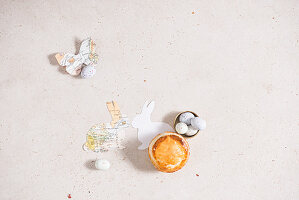 Small Torta Pasqualina, sugar eggs and paper Easter decorations