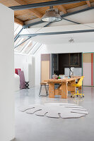 Rug in shape of Swiss cheese plant leaf in loft-style studio