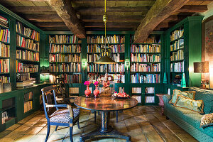 Library with green accents and rustic wooden beams