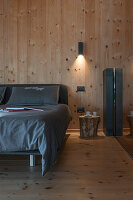 Double bed in bedroom with wood panelling