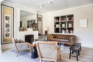 Brown leather couch and armchairs in seating area in living room