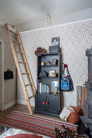 Shelf cupboard and ladder in children's room with wallpaper