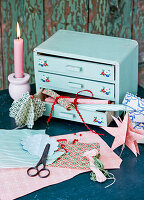 Blue sewing box, coloured paper and paper decorations