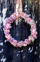 Wreath of hydrangea flowers on dark wood