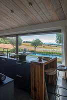 Kitchen island with adjoining wooden breakfast bar