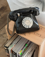 Bakelite telephone on wine crate used as side table