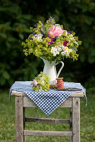 Rural summer bouquet with roses, lady's mantle, feverfew, lavender and carnations