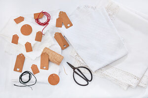 Gift tags, white cloths and napkins with lace trims