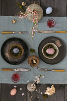 Easter place setting with black and grey ceramics and linen table runner
