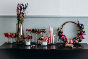 DIY wreaths made of dried flowers and fresh summer flowers and lanterns