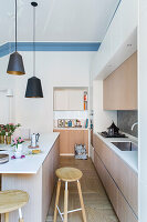 Bright kitchen with kitchen island in a renovated old flat