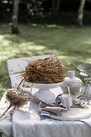 Place setting and nest on Easter table in the garden