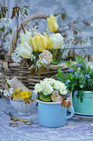 Spring arrangement with primroses, forget-me-nots, tulips, serviceberry blossom and winter aconites