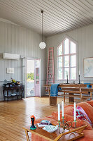 Open-plan living room with wooden floor in converted chapel