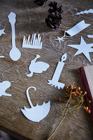 Paper cut-outs with various motifs on a wooden table while crafting