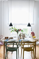 Set dining table and classic chairs below pendant lamps