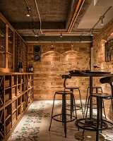 Wall panelling made of old wine crates and floor tiles with a vine motif in a wine cellar
