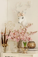 Faux hunting trophy and cherry blossom