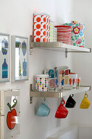 Cups and storage tins on kitchen shelving