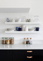 Crockery shelves and dried food in monochrome Reigate kitchen, Surrey, UK