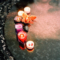 Colourful scented candles on a black tabletop