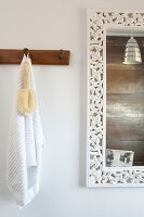 Bathroom detail with ornately carved mirror frame in London home England UK