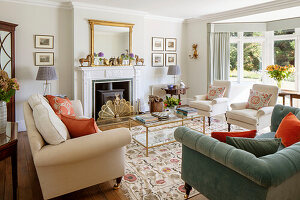 Various pieces of upholstered furniture in front of the fireplace in the living room