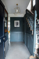 Hallway with dark walls and golden ceiling light