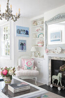 Bright living room with fireplace, chandelier and antique toys