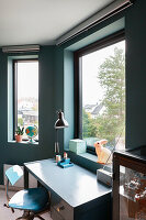 Desk by the window with a view of houses and trees